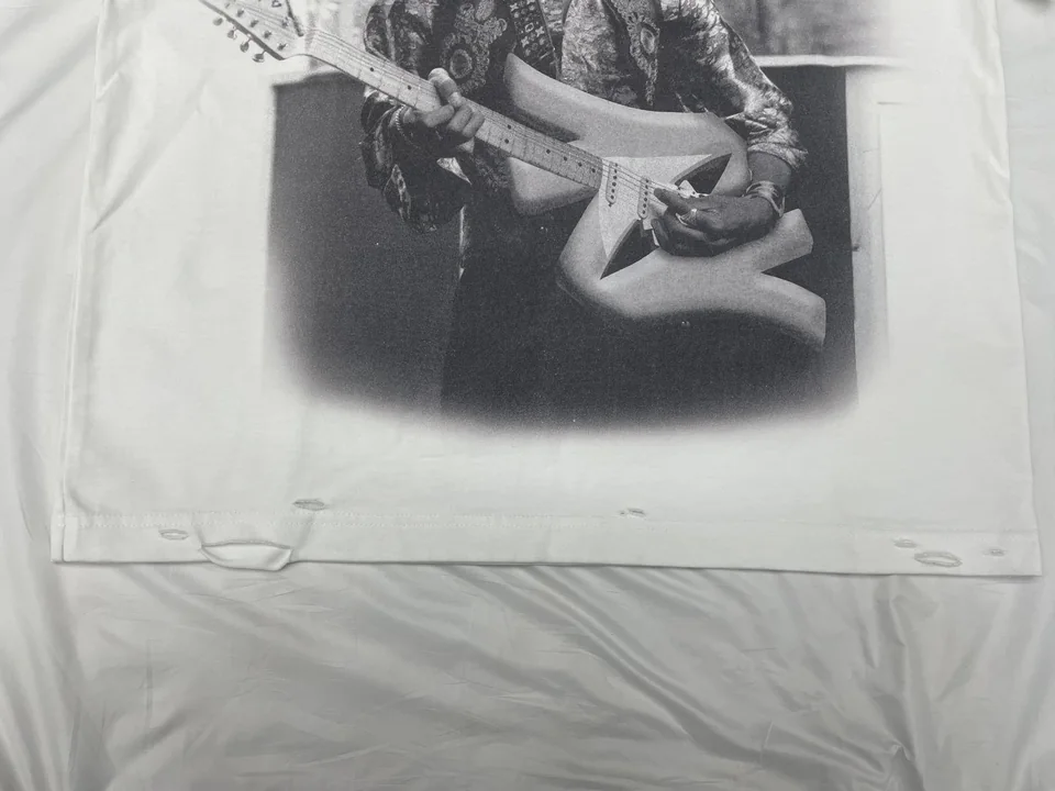 Graphic print and distressed hem on a white T-shirt sample